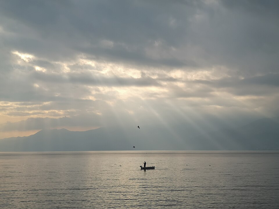 A lone fisherman working from a small boat at first light on the Kvarner Bay