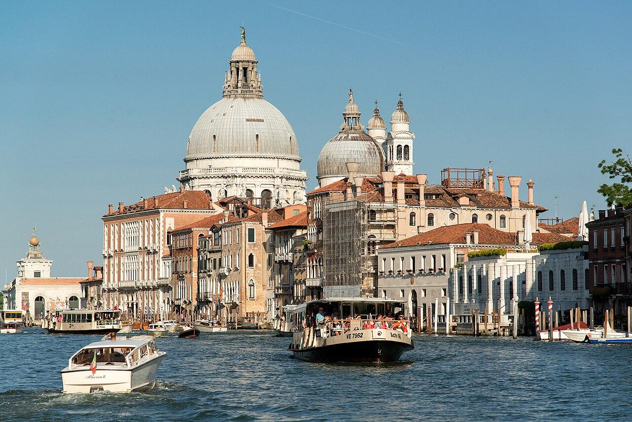 A vaporetto crossing the Grand Canal near the domes of Santa Maria della Salute in Venice