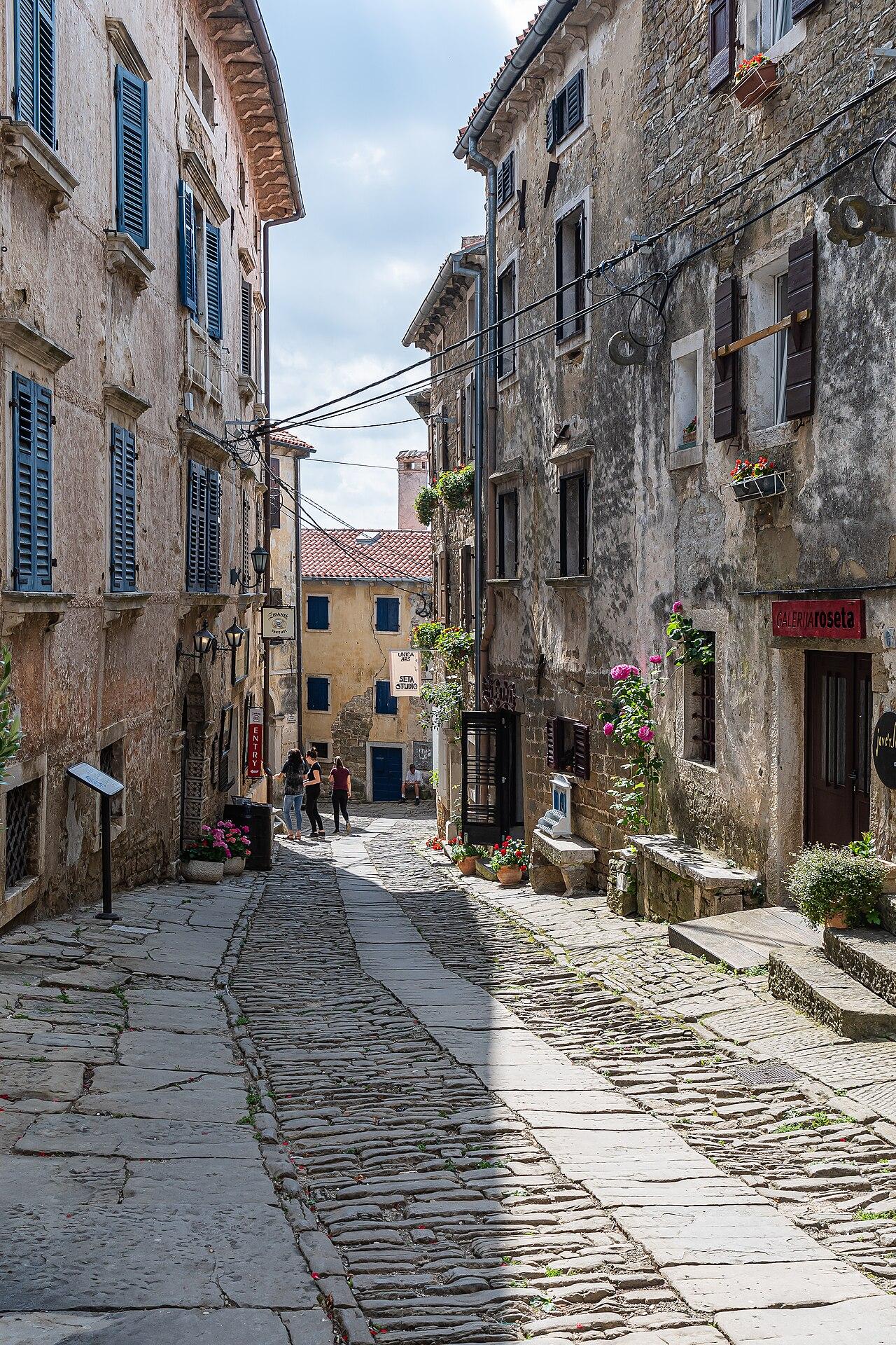 A narrow stone lane winding between old buildings in Grožnjan